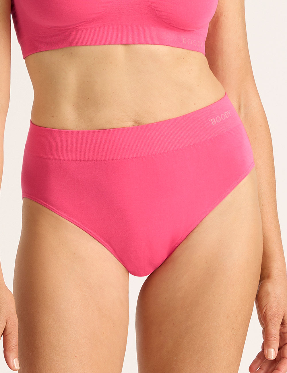 Person wearing bright pink high-waisted bikini bottom underwear