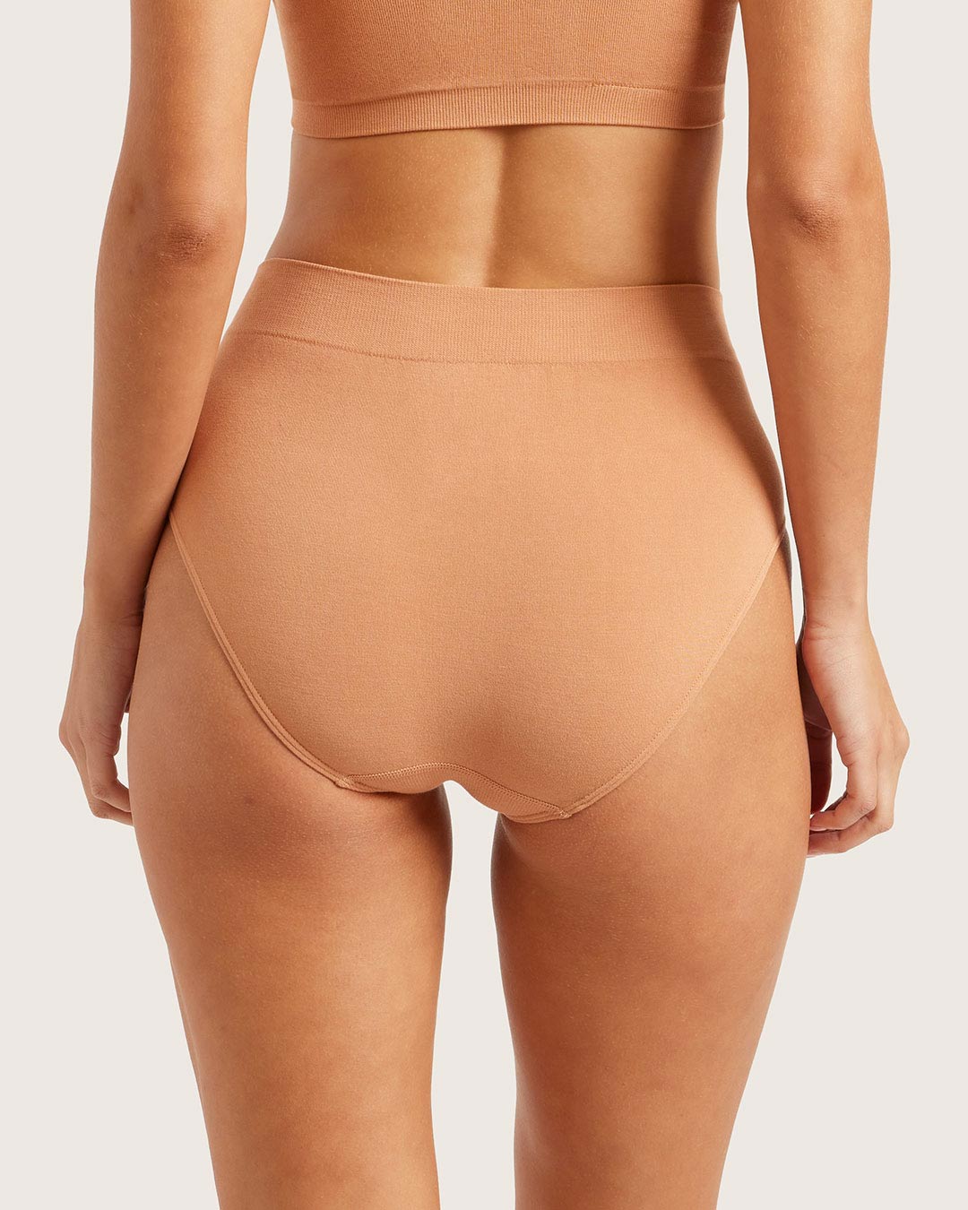 Tan high-waisted underwear on a plain background
