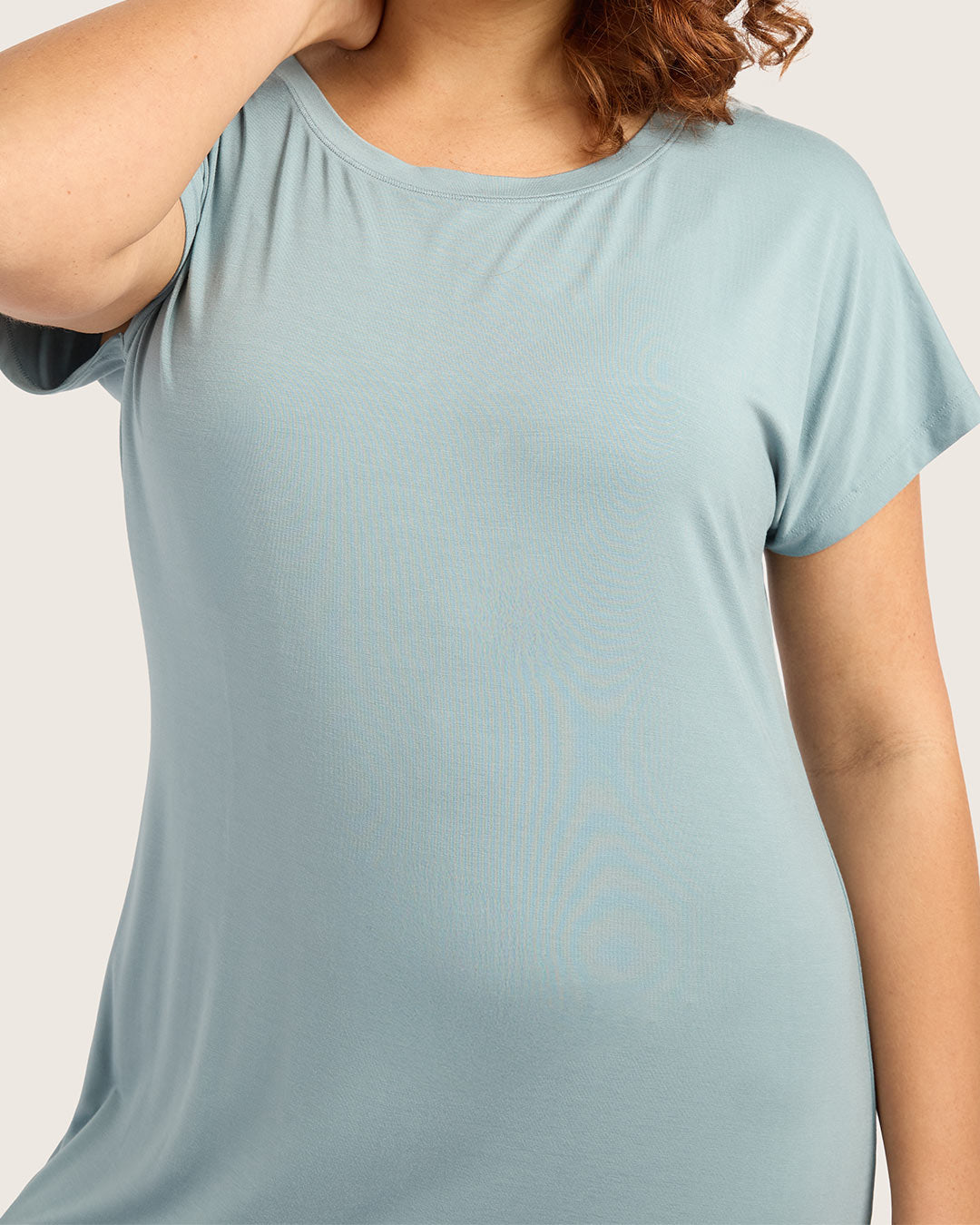 Light blue t-shirt worn by a person on a plain background