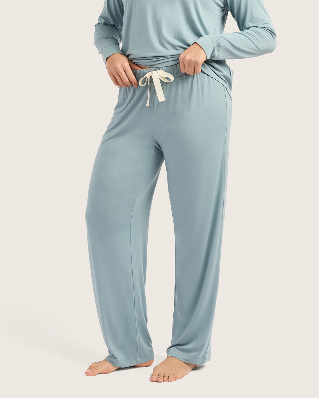 Person wearing a light blue pajama set on a plain background