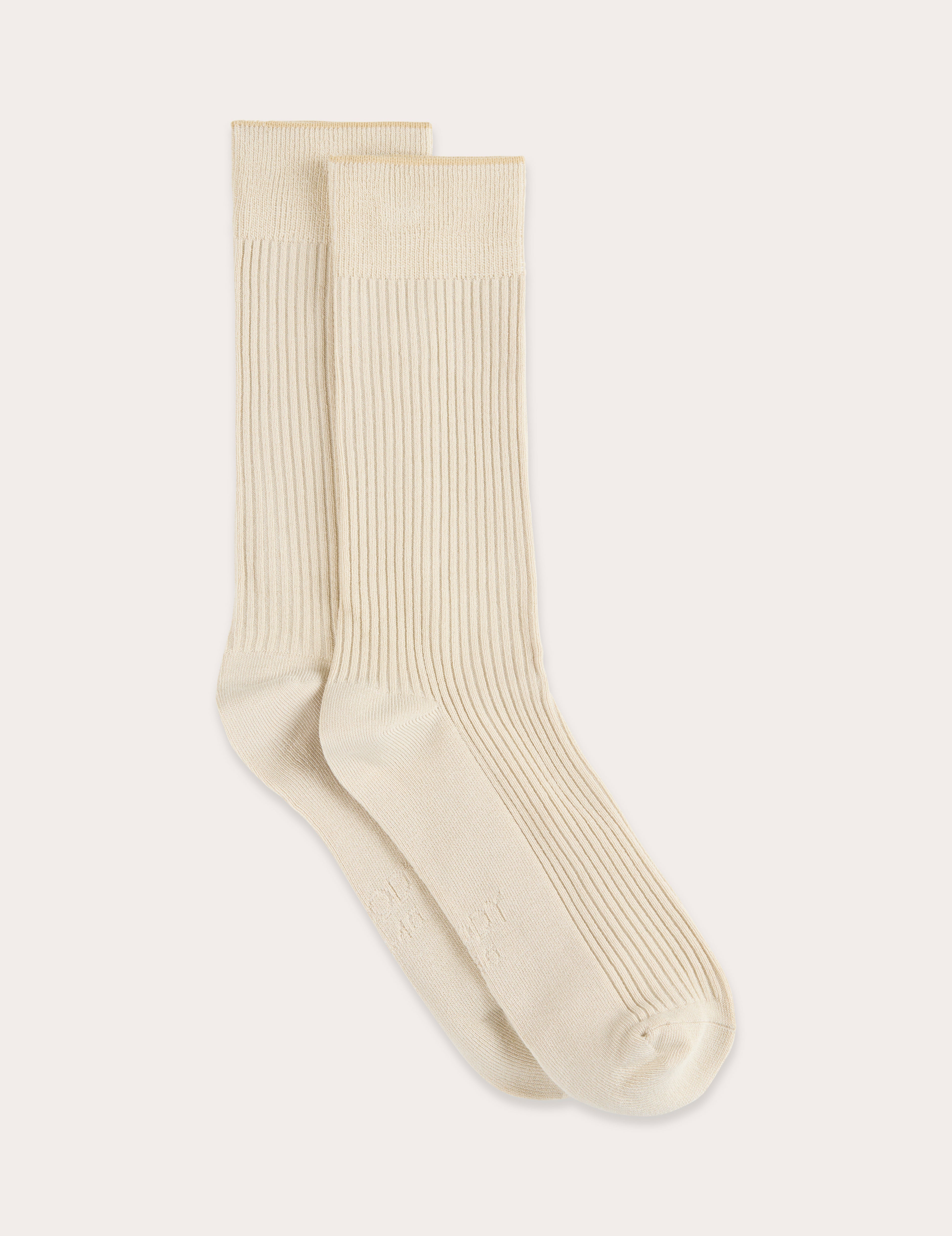 Pair of beige socks on a light gray background