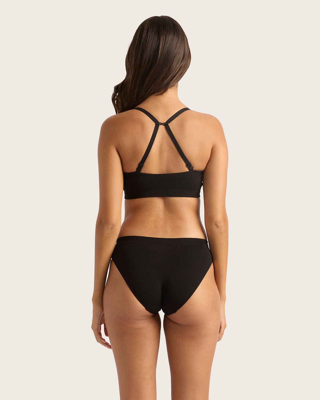 Black underwear set on a model against a plain background